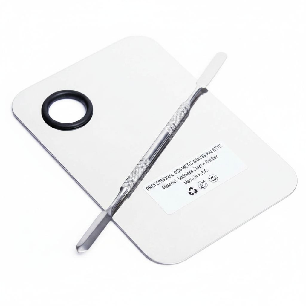 Stainless steel makeup mixing palette with spatula in chrome finish, shown with color swatches — view 2