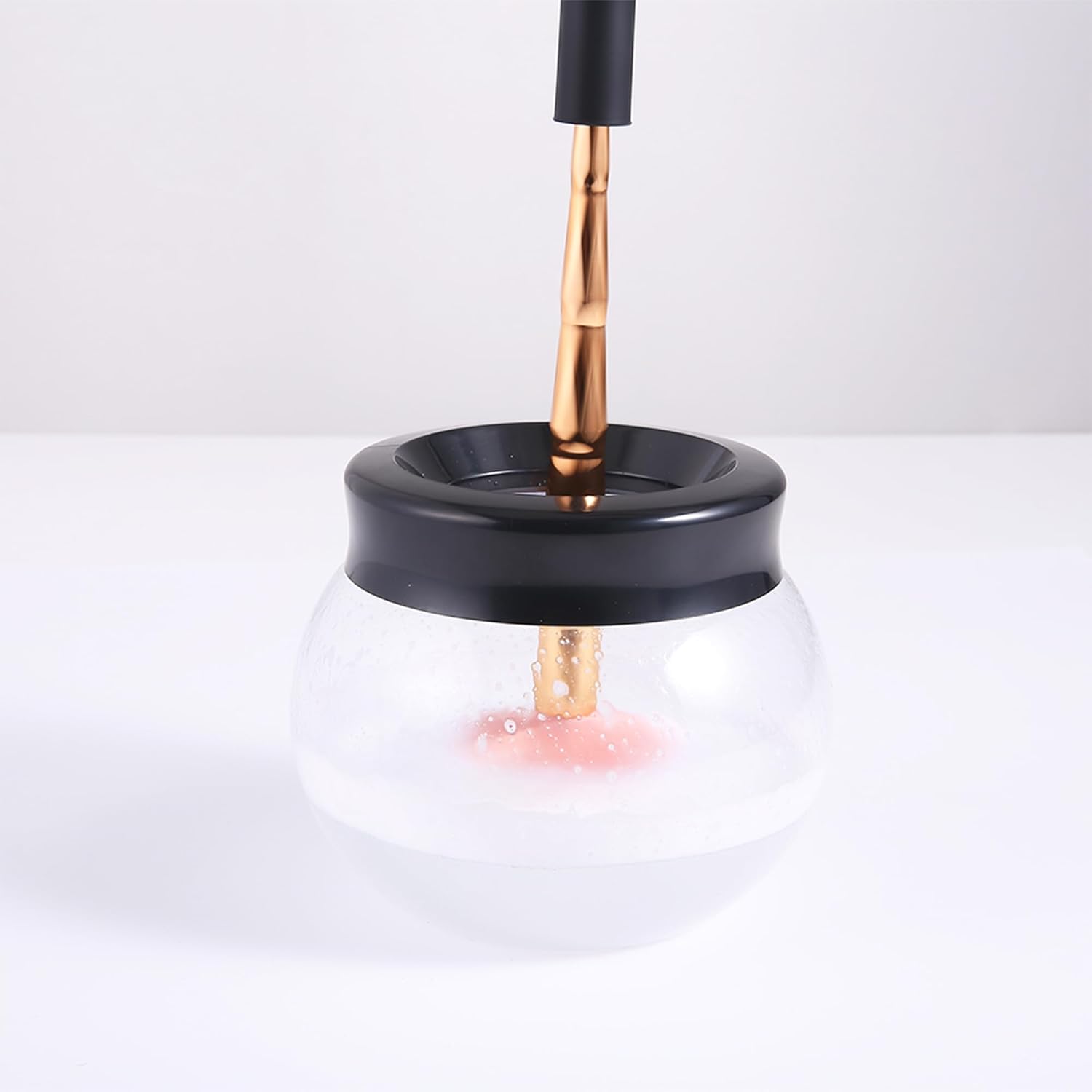 Electric makeup brush cleaner dryer machine in neutral finish, shown cleaning and drying brushes automatically — view 2